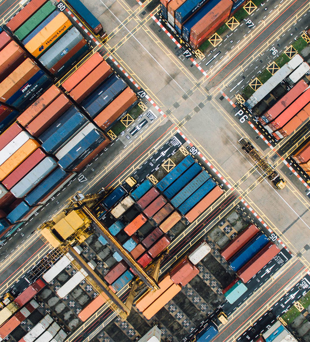 Aerial view of colorful shipping containers at a busy port.
